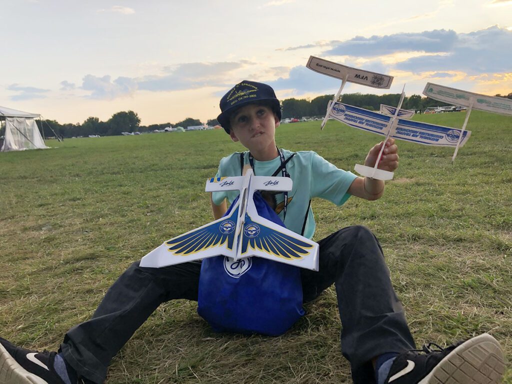 kid playing with toy planes airventure